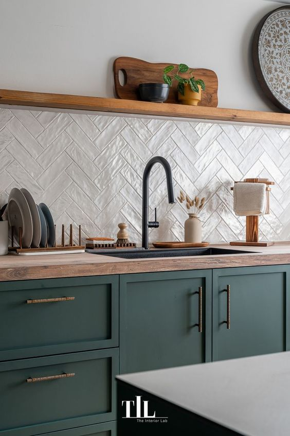 types of countertops: Beautiful kitchen with green cabinets.