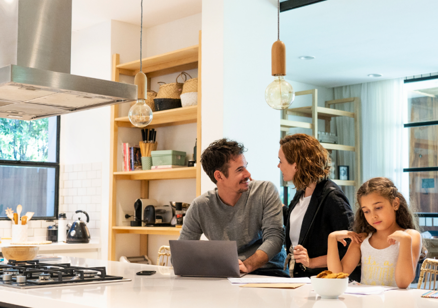 A family enjoys their bright, modern North Vancouver kitchen post-renovation