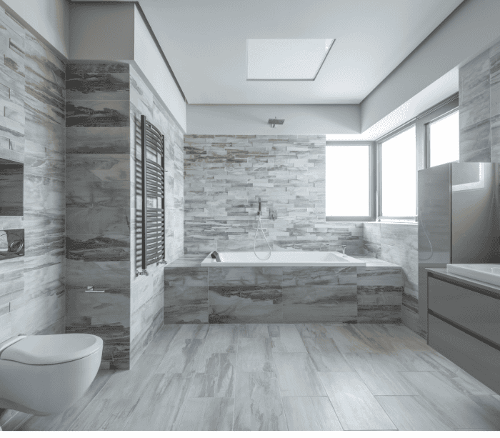 Modern bathroom with marble tiles and glass shower, bathroom trends 2024