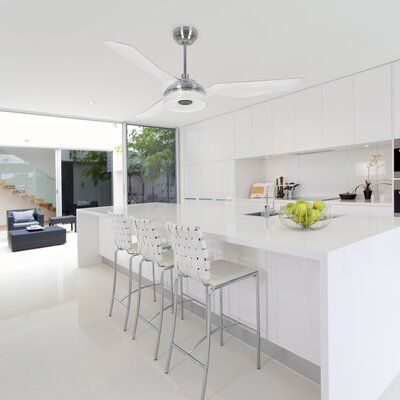 Modern kitchen style 2024 with minimalist design, white countertops, sleek cabinets, and bar stools in a bright setting.