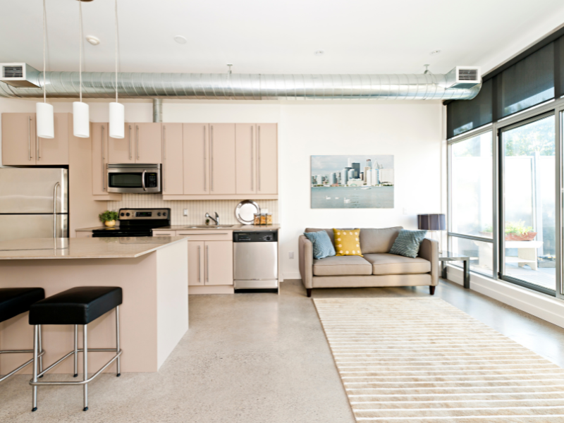Bright and modern Vancouver condo renovation with an open kitchen layout, stylish cabinets, and cozy seating.
