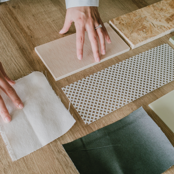 Designer selecting fabric, wood, and material samples for a Vancouver interior design project.