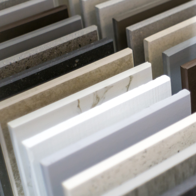 quartz costs: Close-up of quartz countertop samples in various colors and finishes.